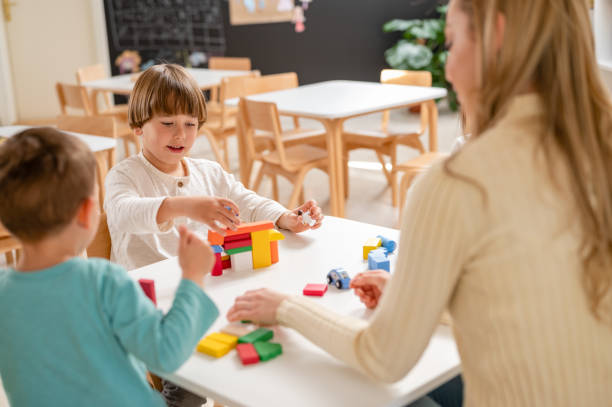 istock Kindergarten children playing with colorful building blocks 1411422238