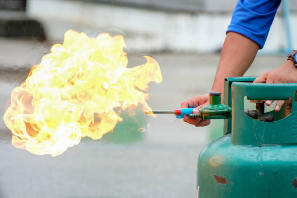 istock Professionals holding gas cylinders, and lighting fires for training and workplace fire protection, Safety at work concept 1411422315