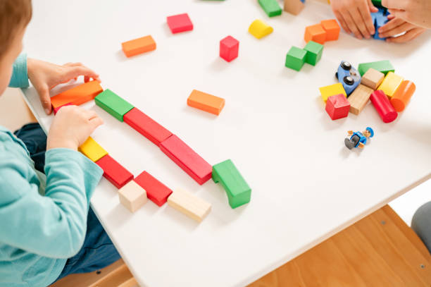 istock Kindergarten children playing with colorful building blocks 1411422369