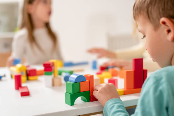 istock Kindergarten children playing with colorful building blocks 1411422421