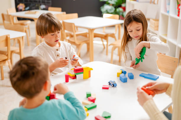 istock Kindergarten children playing with colorful building blocks 1411422444
