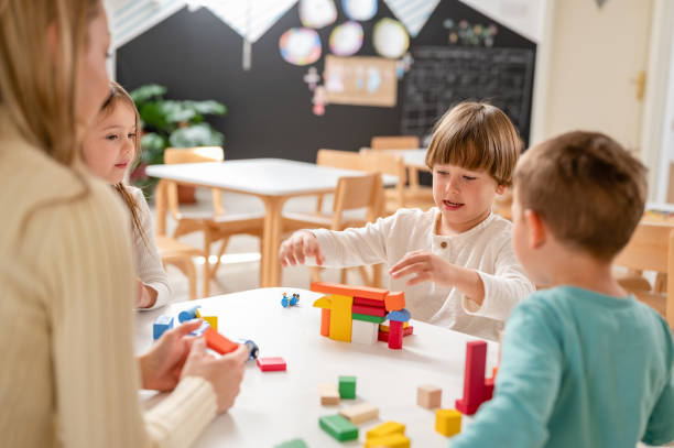 istock Kindergarten children playing with colorful building blocks 1411423229