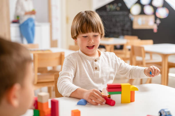 istock Kindergarten children playing with colorful building blocks 1411423233