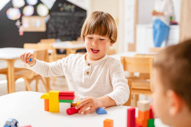 istock Kindergarten children playing with colorful building blocks 1411423249