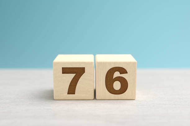 istock Wooden toy blocks forming the number 76. 1411424928