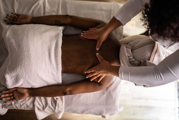 istock Woman getting a message in a spa 1411425215