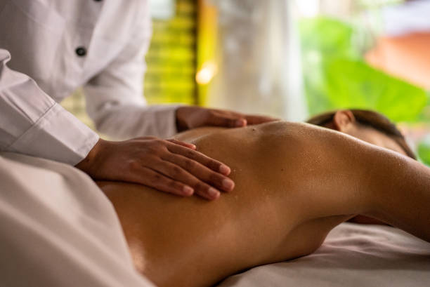 istock Woman getting a message in a spa 1411425415