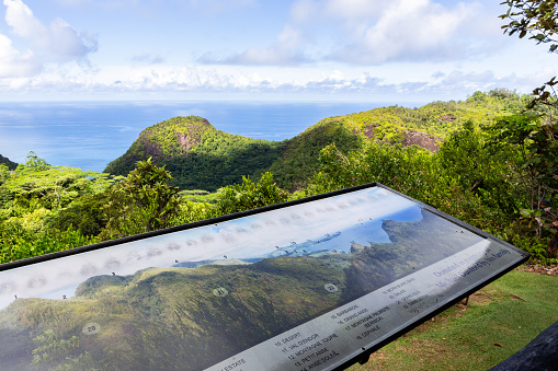 Mahe, Seychelles, 3.05.2021. View from Venn's Town - Mission Lodge viewing platform with panoramic map of Morne Seychellois National Park, lush tropical forest, hills and ocean coast.