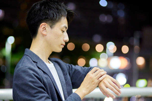 Portrait of young Asian man in the city streets at night outdoors