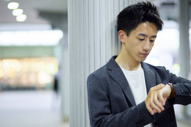 istock Young businessman and train station at night 1411428560