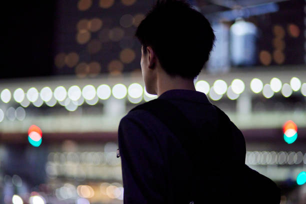 Young businessman and train station at night