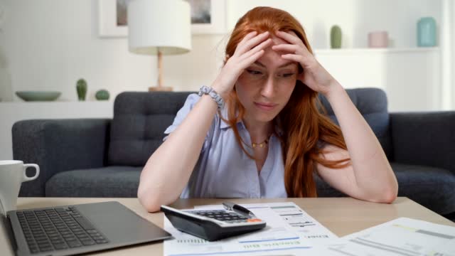 Video about sad woman checking bank statement in financial troubles