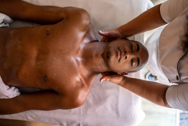 Young man getting a message in a spa Young man getting a message in a spa black male massage stock pictures, royalty-free photos & images