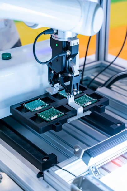 istock automatic robot for print circuit board (PCB)assembly machine during soldering or welding part 1411429991