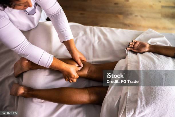 Massage Therapist Massaging A Woman At A Beauty Spa Stock Photo - Download Image Now