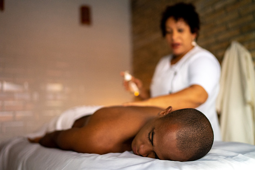 Young man receiving massage at a beauty spa