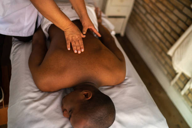 istock Young man receiving massage at a beauty spa 1411434316