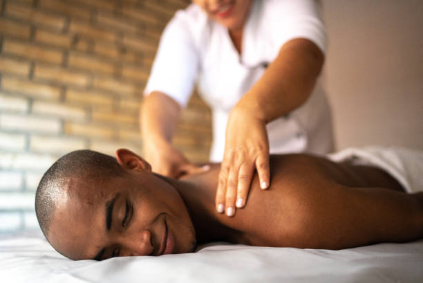 istock Young man receiving massage at a beauty spa 1411434319