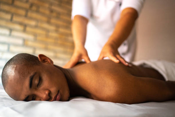 istock Young man receiving massage at a beauty spa 1411434320