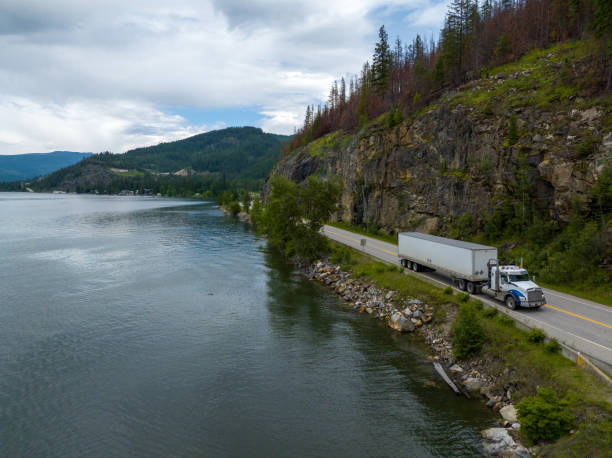 istock Container truck along a scenic road 1411434589