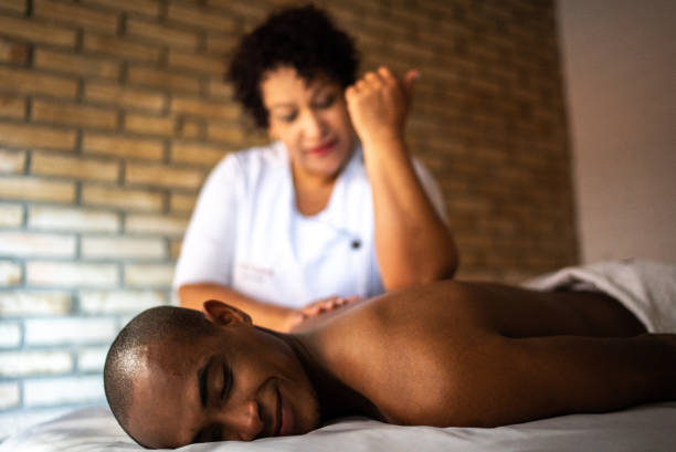 istock Young man receiving massage at a beauty spa 1411434601