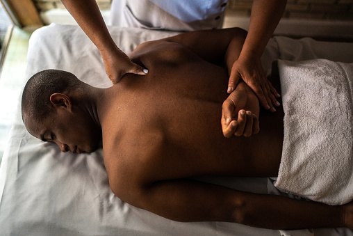 Young man receiving massage at a beauty spa