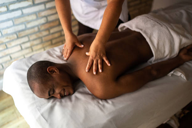 istock Young man receiving massage at a beauty spa 1411435014