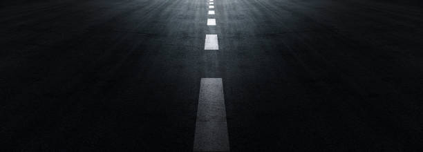 istock Asphalt road texture background, black tarmac surface with white marking stripes, Transport urban background, and Dark street texture detail. 1411436077