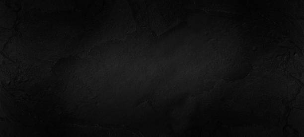 istock Black or dark gray rough grainy stone texture background wall to display your products. 1411436143