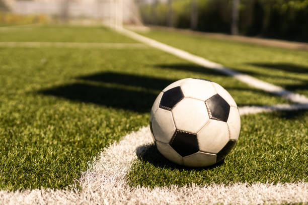 istock soccer on grass and stadium 1411436546