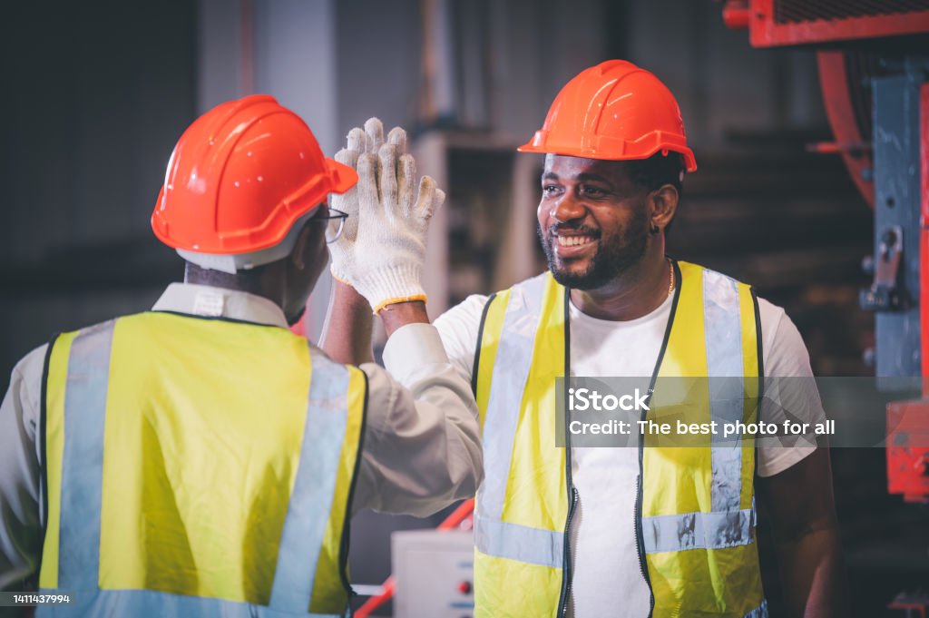 Teamwork African American worker in the factory, Black man afro work heavy industrial Respect Stock Photo