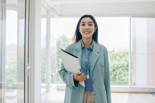 istock A confident young businesswoman walking through a modern office 1411438063