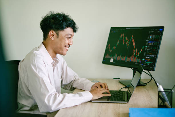 istock Asian man investing or trading using his laptop 1411439075