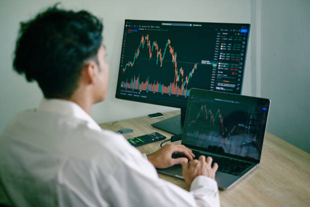 istock Portrait of man focus analyze crypto graph 1411439133