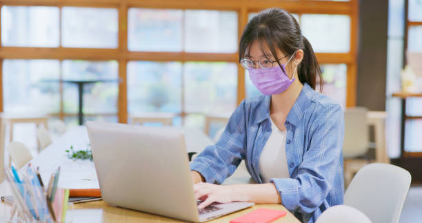 istock woman with mask and computer 1411439565