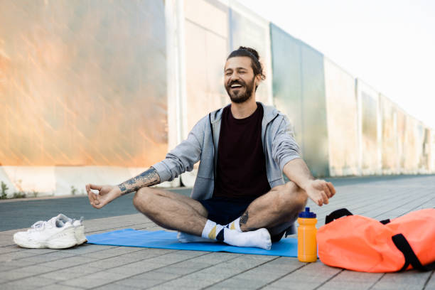 istock Young man meditating outdoors 1411440911