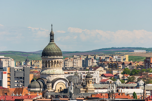 Orthodox cathedral or church from Cluj Napoca saw from an aerial cityscape with many vintage buildings among communist constructions