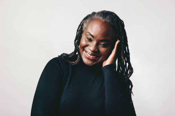 istock Self-confident woman with dreadlocks smiling at the camera 1411446044