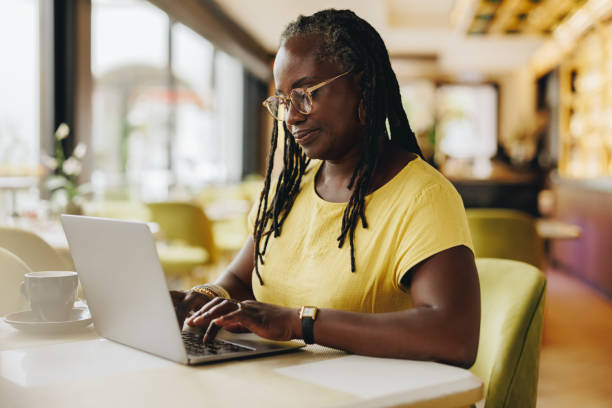 istock Self-employed woman working in a cafe 1411446243