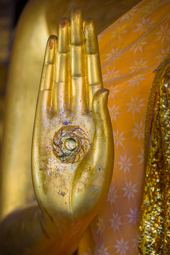 Hands and motifs, the surface of the golden Buddha.