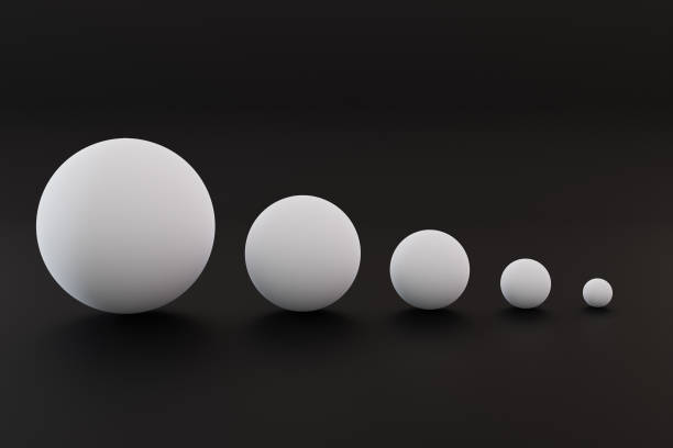 istock Five white balls of different sizes. balls of different sizes on a black background. 1411451145