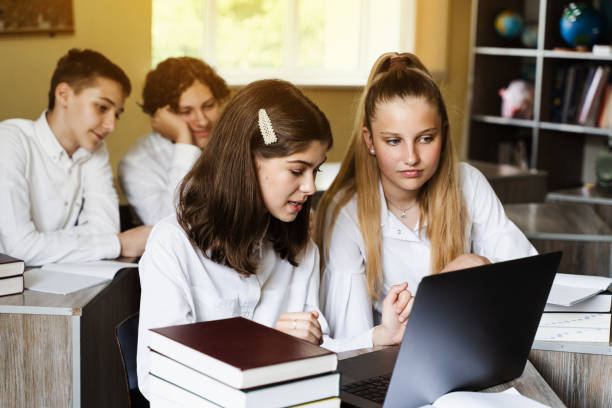 istock Back to school. Children study online on laptop and communicating with classmates online at geography lesson and discuss different countries with globe. 1411451393