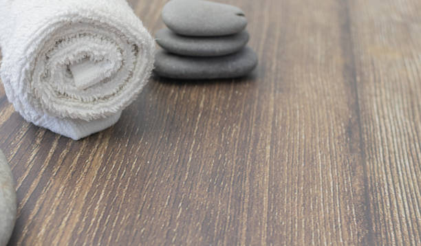 istock White towel with spa stones on wood 1411452039