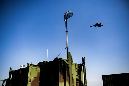 Military army radar system antenna doing surveillance.