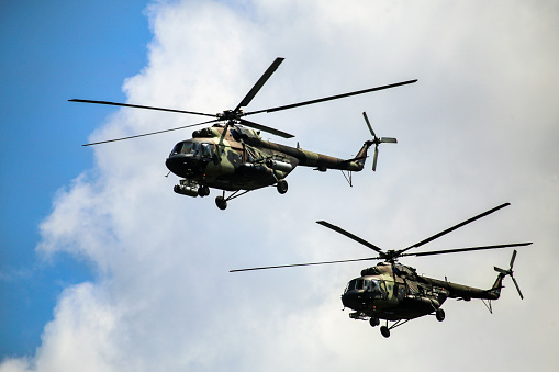 Duxford, UK - May 23, 2015: Two Apache attack helicopters of the UK's Army Air Corps in flight over Cambridgeshire, England. 
