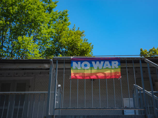 Rainbow flag with word no war . Concept of world peace and no war. stock photo