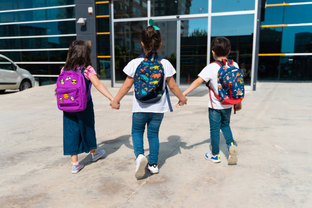 istock Young children walking to school 1411454248