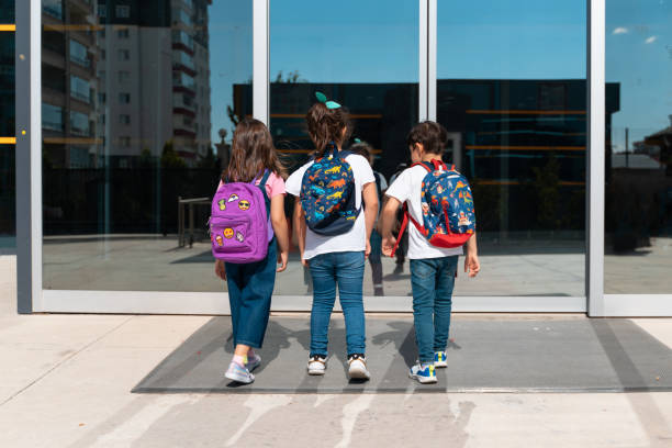 istock Young children walking to school 1411454249
