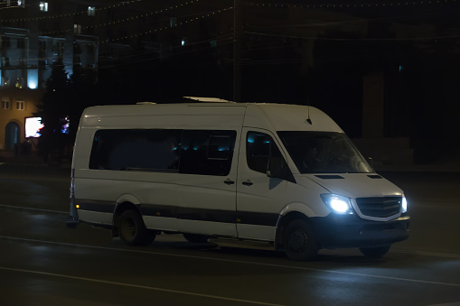 Minibus Moves along the Night Street in the City Center
