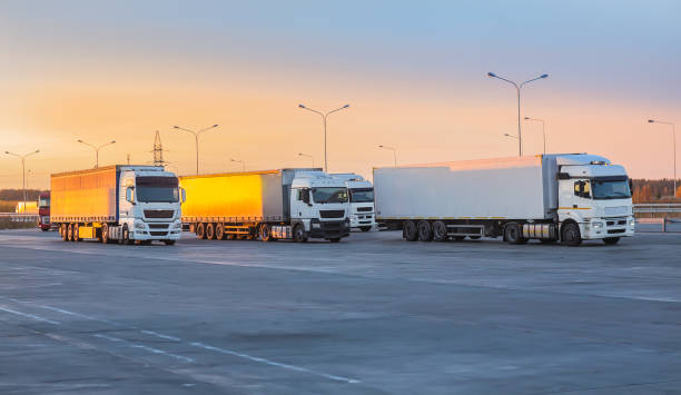 istock Trucks in parking lot on suburban highway 1411454704